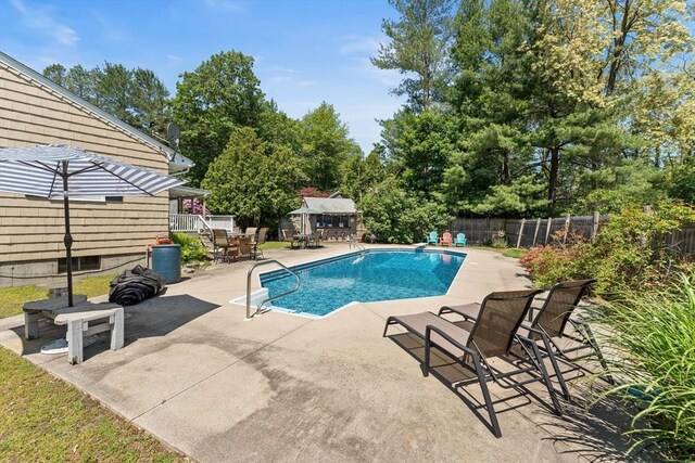1 Redgate Ln, Holden, MA 01520 - view of swimming pool featuring a fenced backyard, a patio area, an outbuilding, and view of wooded area