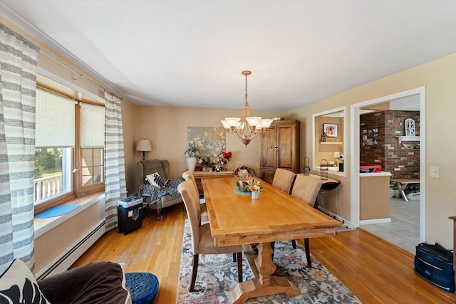 1 Redgate Ln, Holden, MA 01520 - dining area with a baseboard radiator, light wood-style flooring, and a chandelier