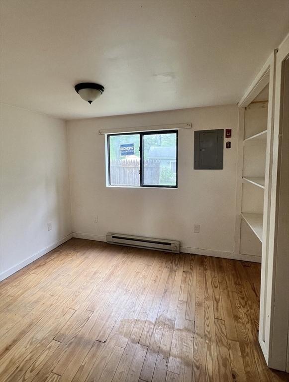 11 Summit Ave, Lakeville, MA 02347 - unfurnished room featuring electric panel, baseboard heating, wood-type flooring, and baseboards