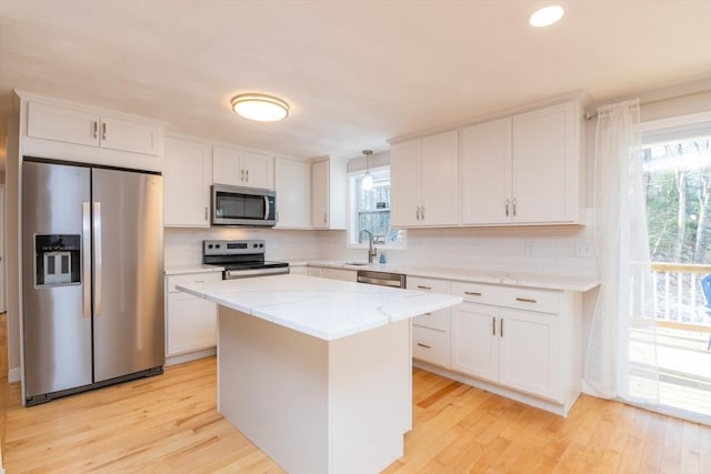 kitchen with white cabinets, a healthy amount of sunlight, and appliances with stainless steel finishes