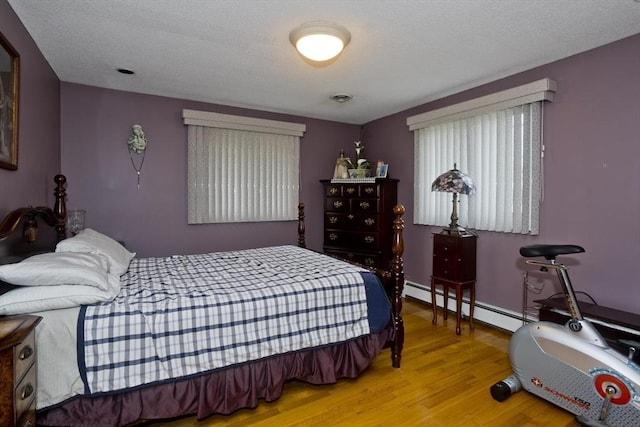 90 Westwood Ave, East Longmeadow, MA 01028 - bedroom featuring baseboards, baseboard heating, and wood finished floors