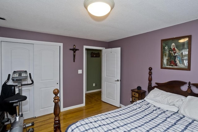90 Westwood Ave, East Longmeadow, MA 01028 - bedroom with baseboards, a textured ceiling, wood finished floors, and a closet