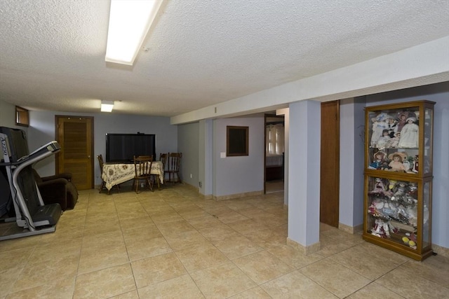 90 Westwood Ave, East Longmeadow, MA 01028 - finished basement with baseboards, a textured ceiling, and light tile patterned floors