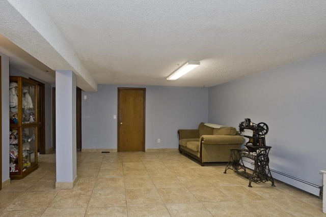 90 Westwood Ave, East Longmeadow, MA 01028 - living area with a baseboard heating unit, a textured ceiling, and light tile patterned floors