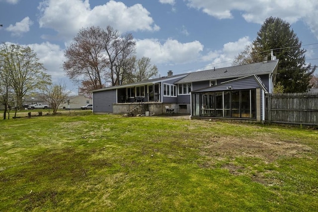 90 Westwood Ave, East Longmeadow, MA 01028 - rear view of house with fence, a lawn, a chimney, and a sunroom