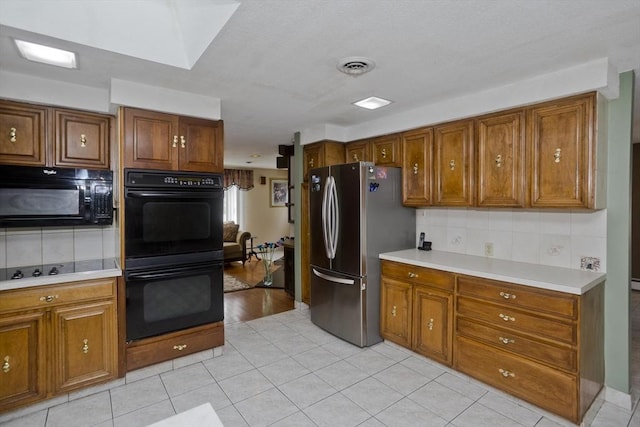 90 Westwood Ave, East Longmeadow, MA 01028 - kitchen with brown cabinets, backsplash, black appliances, and light countertops