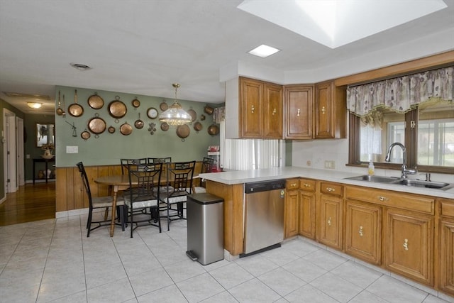 90 Westwood Ave, East Longmeadow, MA 01028 - kitchen featuring a sink, light countertops, stainless steel dishwasher, and brown cabinetry