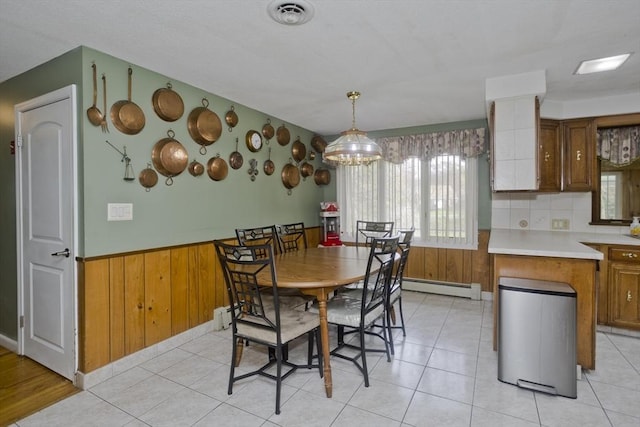 90 Westwood Ave, East Longmeadow, MA 01028 - dining area featuring wainscoting, a chandelier, wood walls, a baseboard radiator, and visible vents