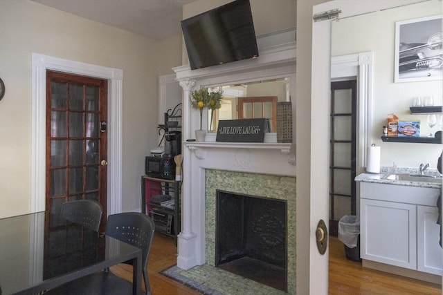 living room featuring sink and light hardwood / wood-style floors