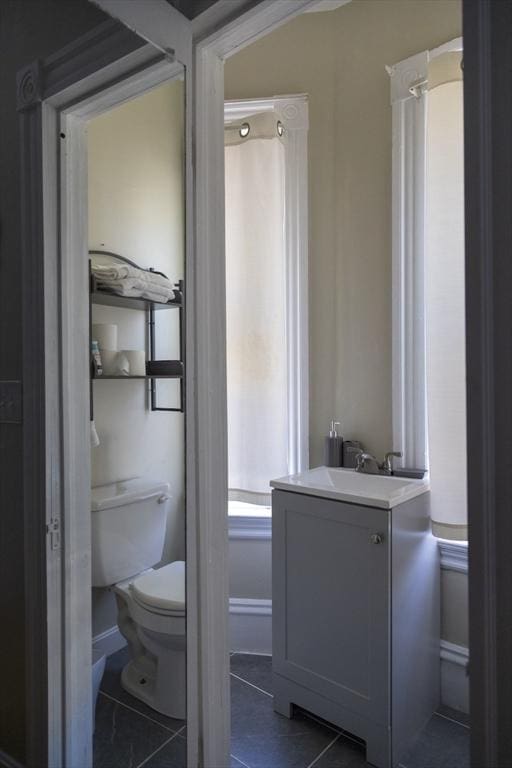 bathroom with tile patterned floors, toilet, and vanity