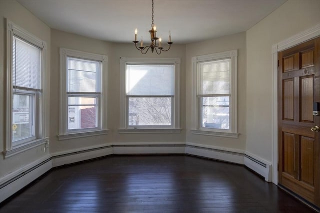 unfurnished dining area featuring a baseboard heating unit, a chandelier, and dark hardwood / wood-style floors