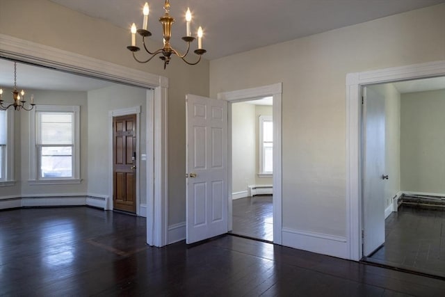 unfurnished room featuring dark hardwood / wood-style flooring, a chandelier, and a baseboard heating unit