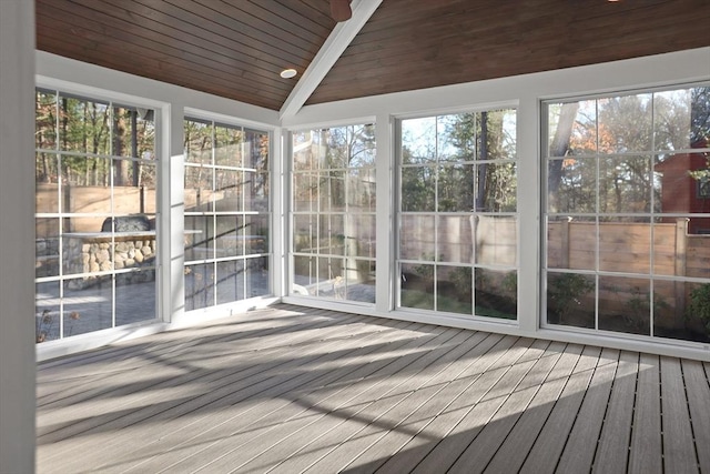 unfurnished sunroom featuring lofted ceiling with beams and wooden ceiling