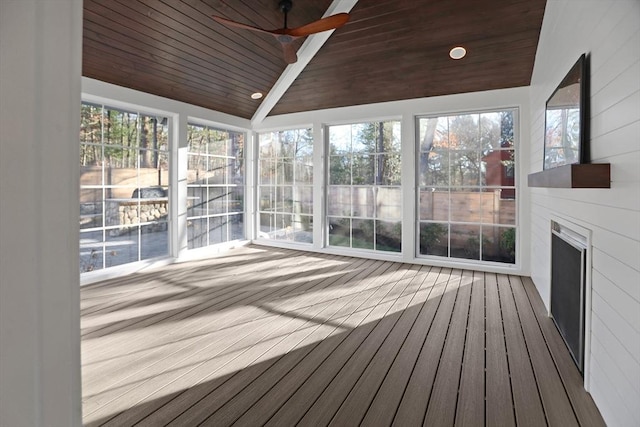 unfurnished sunroom featuring ceiling fan, wood ceiling, and vaulted ceiling