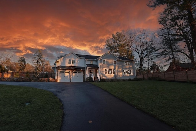 view of front facade featuring a lawn and a garage