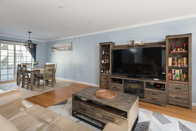 27 Mill St Unit B, Quincy, MA 02169 - living area featuring crown molding, wood finished floors, a chandelier, and baseboards