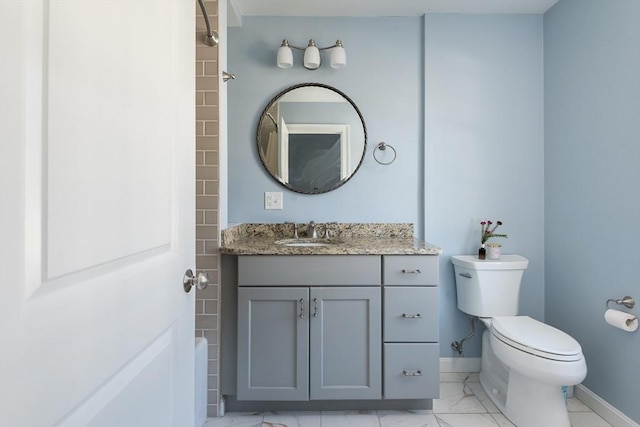 27 Mill St Unit B, Quincy, MA 02169 - full bath with marble look tile flooring, toilet, vanity, and baseboards
