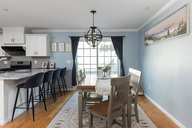 27 Mill St Unit B, Quincy, MA 02169 - dining room with a chandelier, light wood-style floors, crown molding, and baseboards