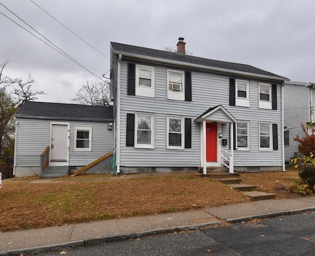 colonial-style house featuring cooling unit