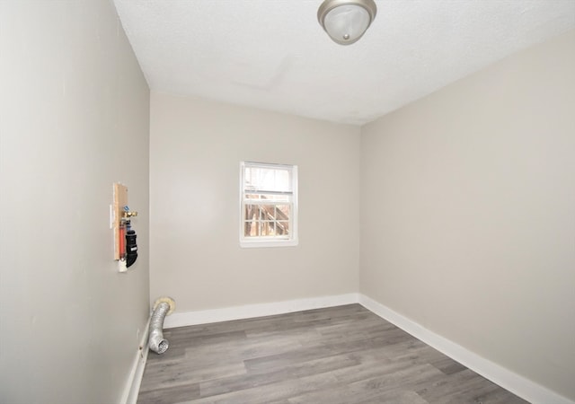 clothes washing area with light hardwood / wood-style floors