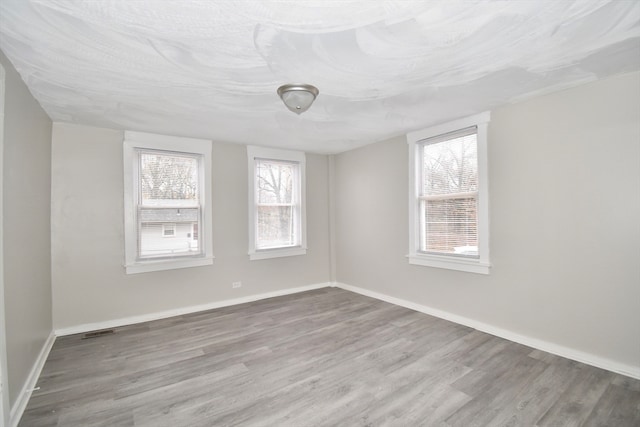 empty room with hardwood / wood-style flooring