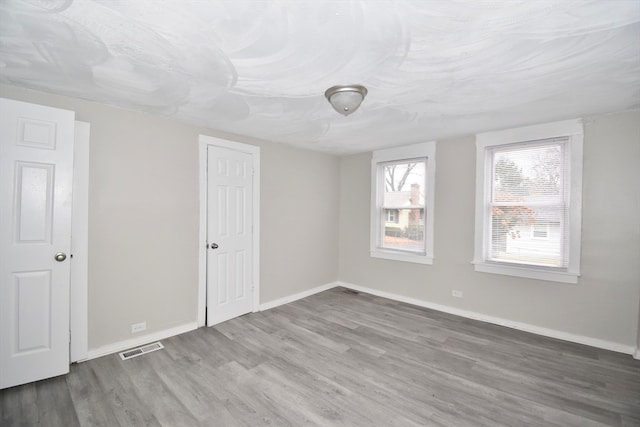 empty room with hardwood / wood-style flooring