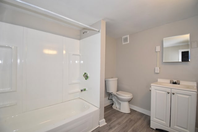 full bathroom with hardwood / wood-style flooring, vanity, toilet, and shower / tub combination