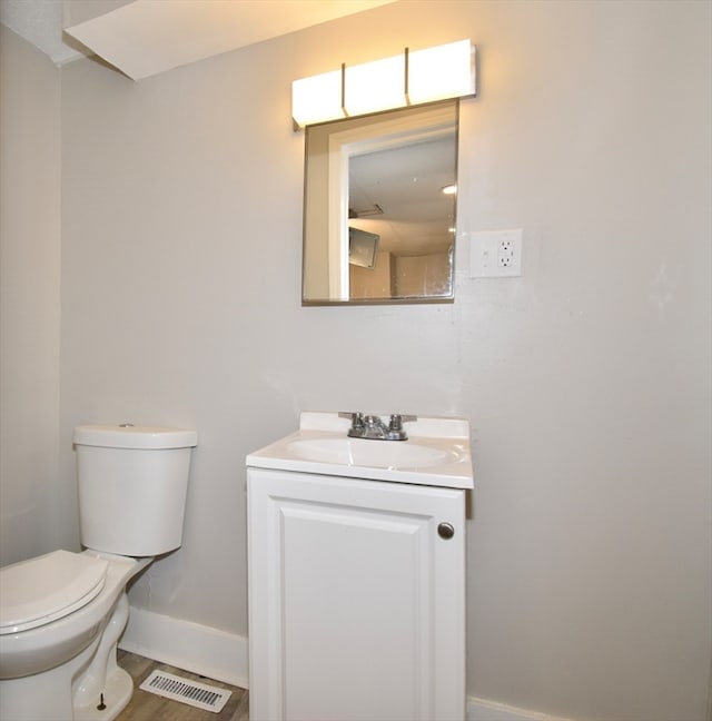 bathroom featuring hardwood / wood-style flooring, vanity, and toilet