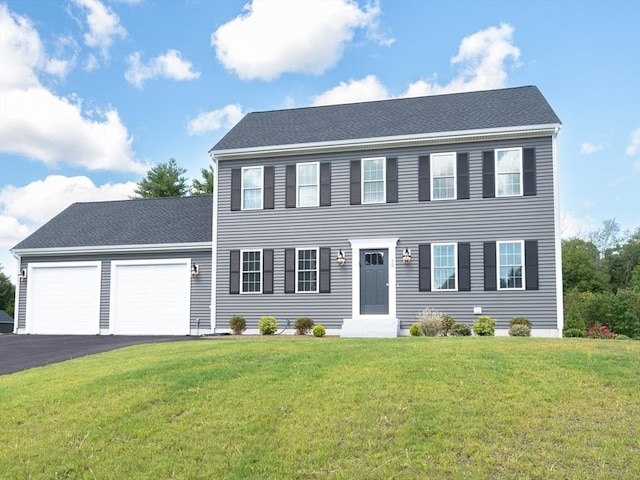 18 Tispaquin St, Middleboro, MA 02346 - colonial house featuring an attached garage, asphalt driveway, and a front lawn