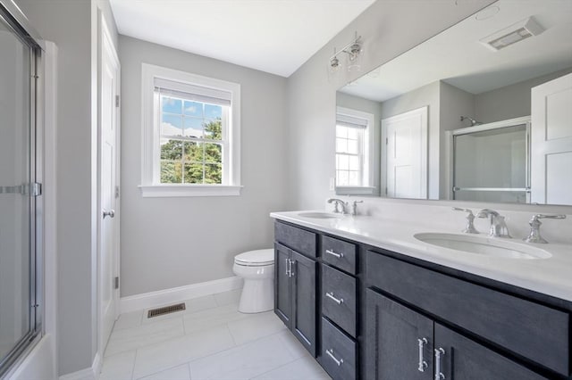 18 Tispaquin St, Middleboro, MA 02346 - full bath with a shower with shower door, baseboards, double vanity, and toilet