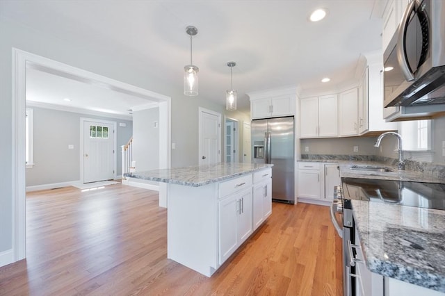 18 Tispaquin St, Middleboro, MA 02346 - kitchen featuring stainless steel appliances, a sink, white cabinets, light wood-type flooring, and recessed lighting