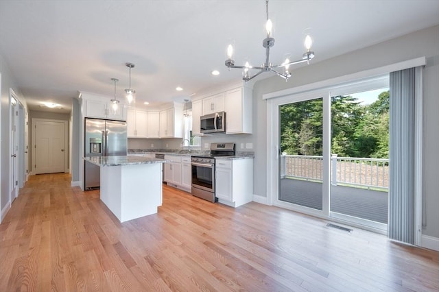 18 Tispaquin St, Middleboro, MA 02346 - kitchen featuring stainless steel appliances, a kitchen island, a chandelier, white cabinets, and recessed lighting