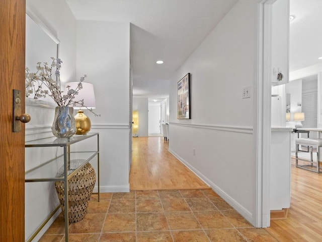 corridor with hardwood / wood-style flooring