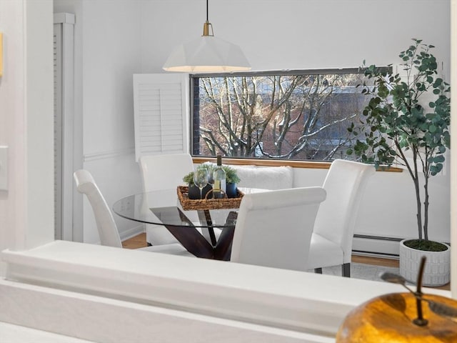 dining space featuring a baseboard heating unit