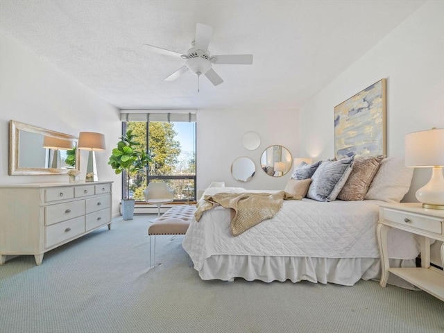 carpeted bedroom featuring ceiling fan, floor to ceiling windows, and a textured ceiling