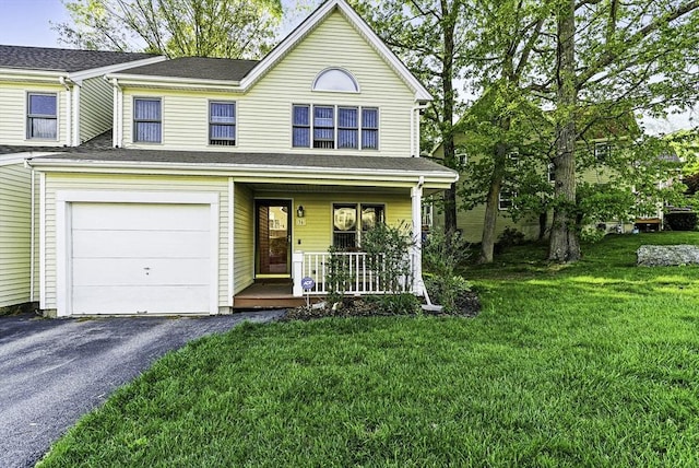 view of front of property with a porch, a garage, a front lawn, and driveway