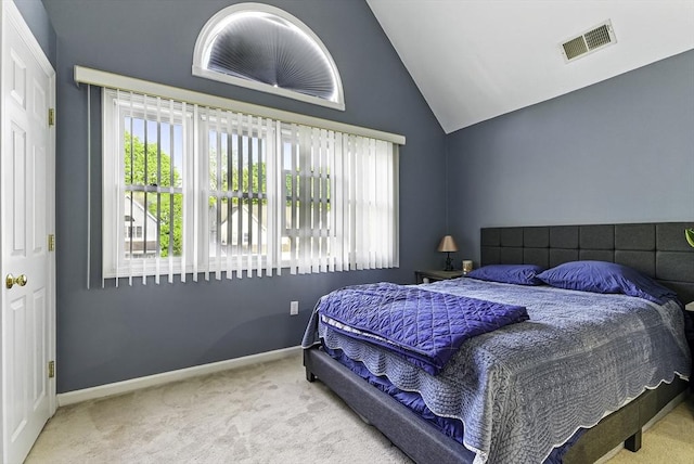 bedroom with carpet flooring, vaulted ceiling, and baseboards