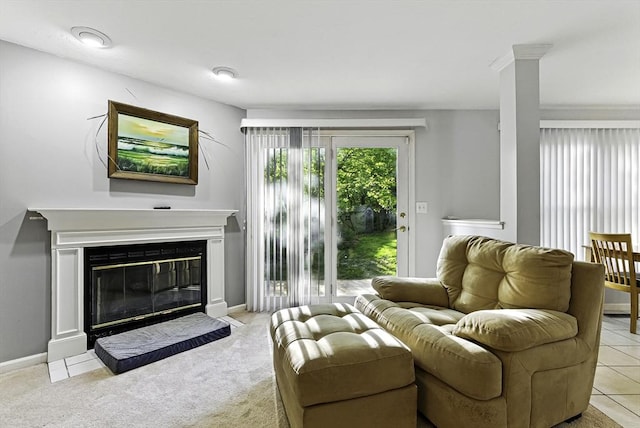 carpeted living area with a glass covered fireplace and baseboards