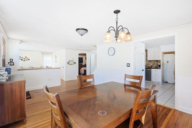 dining area with a chandelier and light wood finished floors