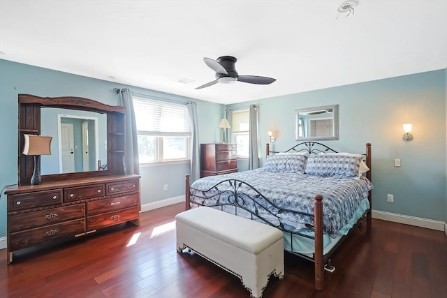 bedroom featuring baseboards, wood finished floors, and a ceiling fan