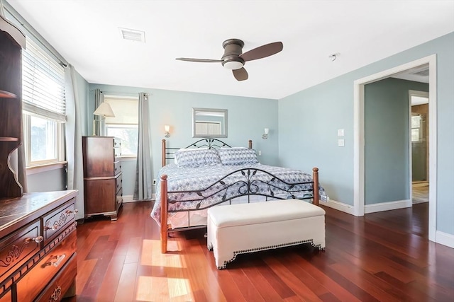bedroom featuring wood finished floors, baseboards, and ceiling fan