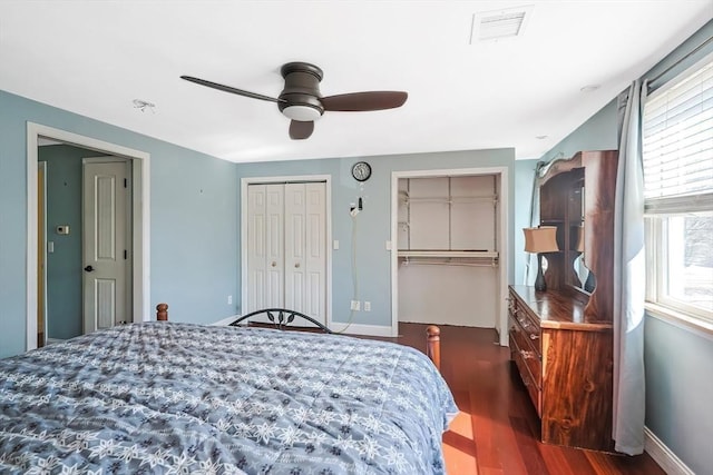 bedroom with wood finished floors, baseboards, and a ceiling fan
