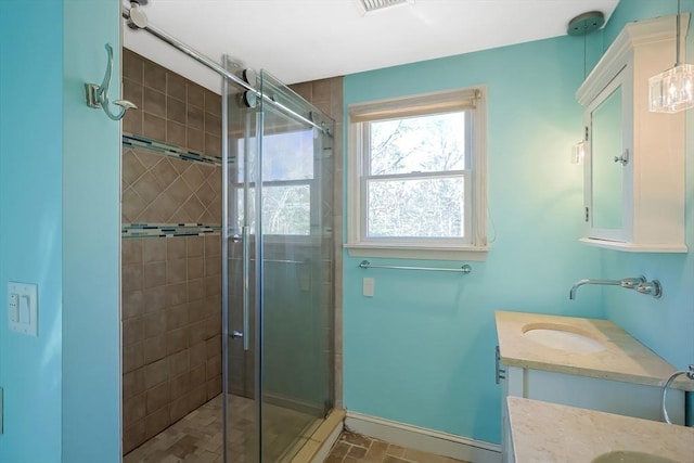 full bath with a shower stall, vanity, and baseboards
