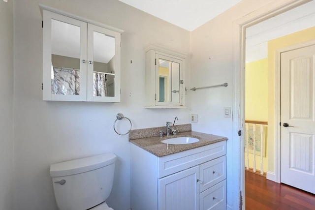 full bath with vanity, toilet, and wood finished floors