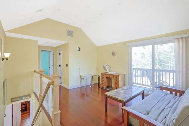 dining space with vaulted ceiling, wood finished floors, and baseboards