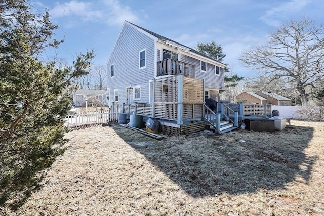 back of property featuring a balcony, central AC, a jacuzzi, and a wooden deck