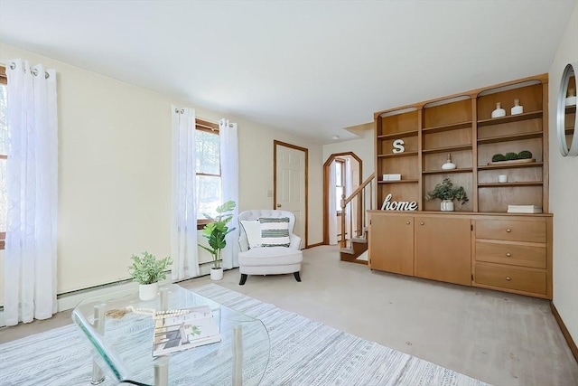 living area with stairway and baseboards