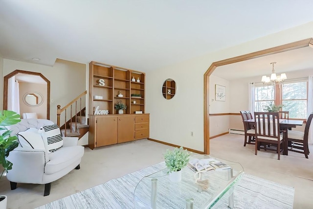 living area with baseboards, stairway, light colored carpet, arched walkways, and a notable chandelier