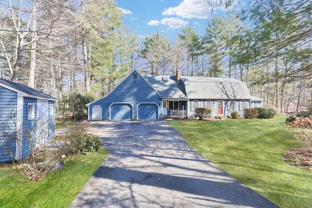 cape cod house with aphalt driveway, covered porch, a front yard, a garage, and a chimney