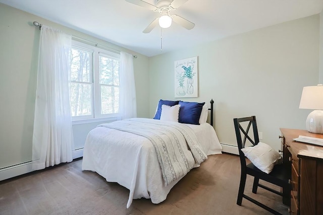 carpeted bedroom featuring baseboard heating and ceiling fan